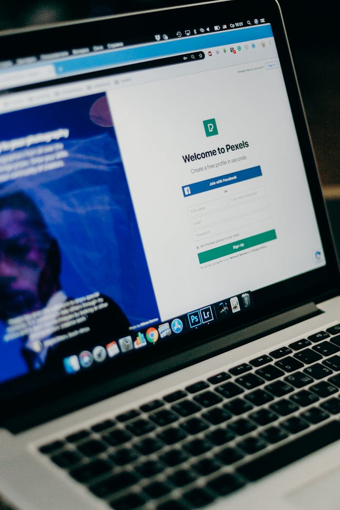 contact-img Close-up view of a laptop displaying a sign-up page for an online platform.